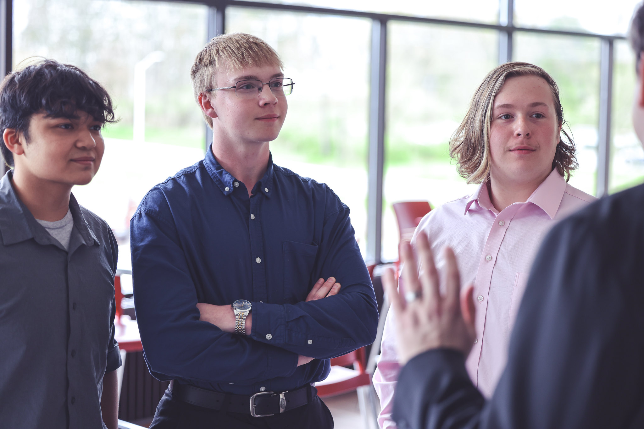 Three participants of the Soaring Collegiate Competition network with an entrepreneur