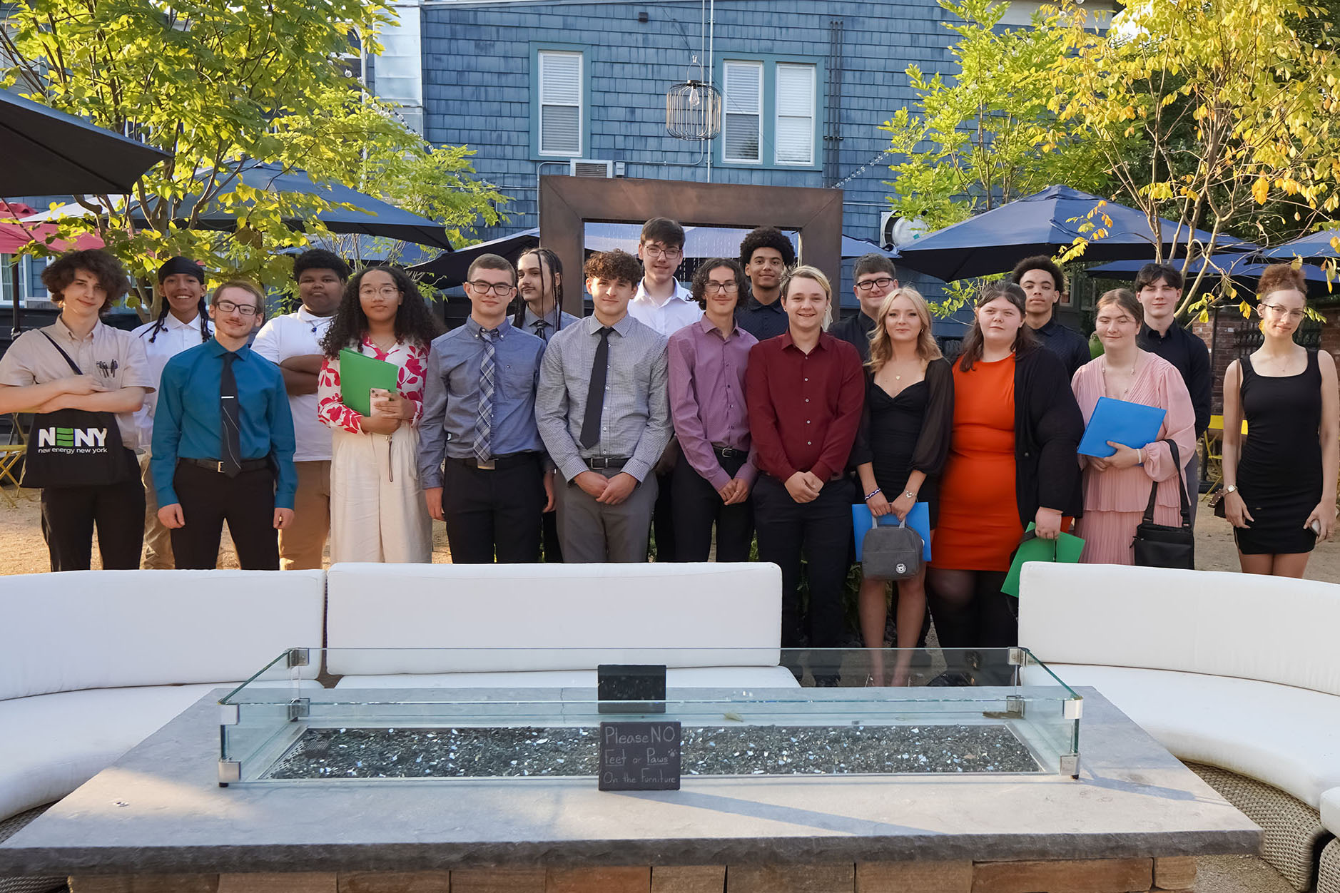 A group of young entrepreneurs smile outside